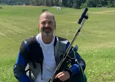 Marty Gunderson posting with Rifle at shooting compitition